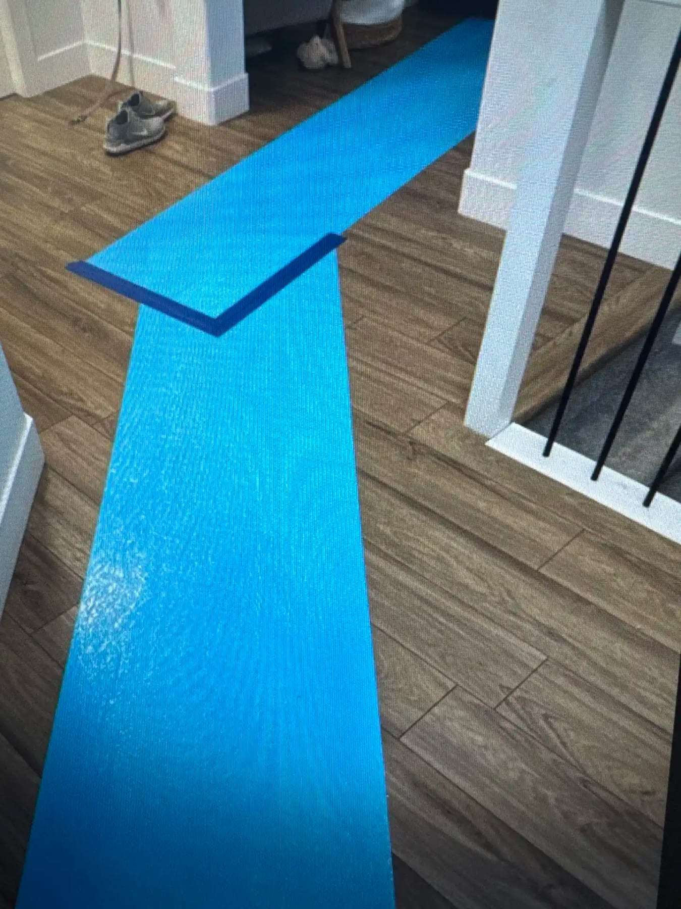 Protective runner laid across tile flooring between rooms