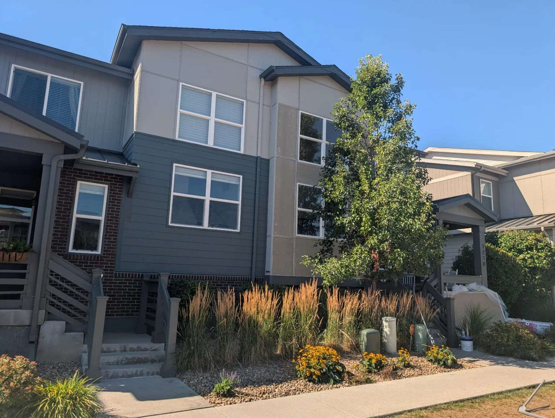 Row of modern townhomes with front gardens